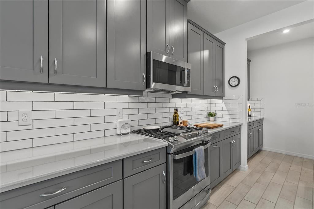 9291 Starry Night Avenue Sarasota, FL 34241 - Photo 8 of 30 a kitchen with stainless steel appliances granite countertop a sink stove and cabinets