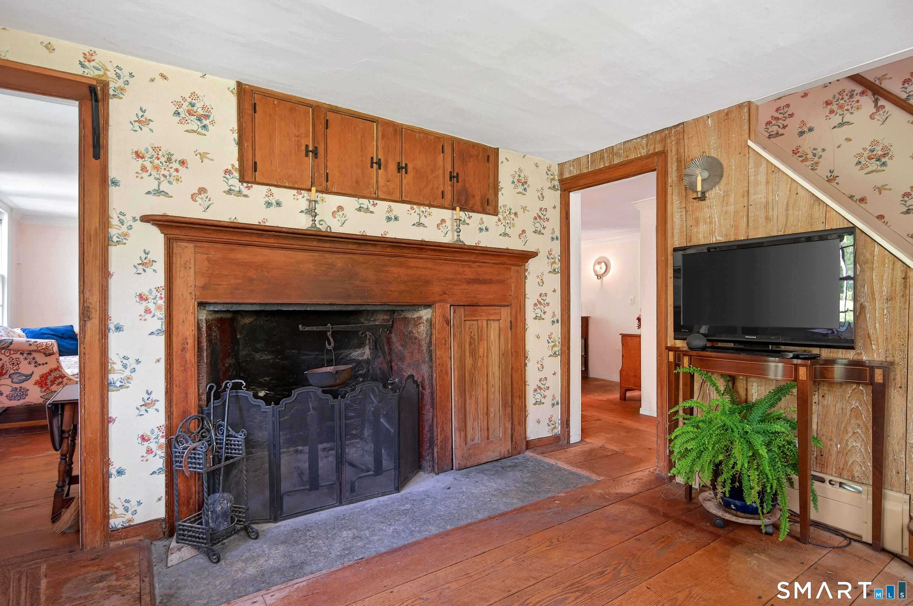 6 High Rock Road Newtown, CT 06482 - Photo 14 of 40 a living room with furniture a flat screen tv and a fireplace