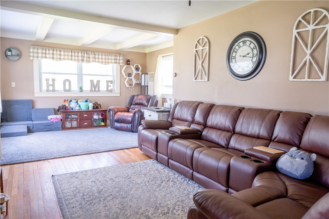 3365 Trapping Brook Road Wellsville, NY 14895 - Photo 6 of 47 The two-sectioned living room is a nice feature. The front has hardwoods, and this space is good for movie nights or gaming. The back section has new carpeting and architectural beams and is perfect for reading and relaxing.