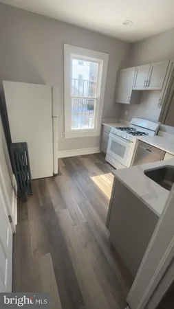 a view of a kitchen with a sink dishwasher and a fireplace