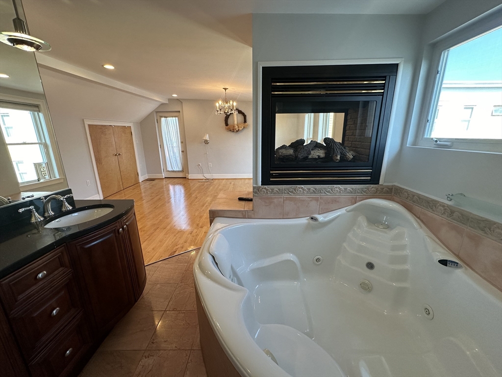 17 Herbert Road, Unit 1 Arlington, MA 02474 - Photo 24 of 26 a bathroom with a tub sink and mirror