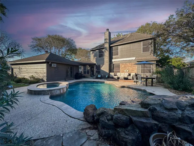 a view of a swimming pool with a patio