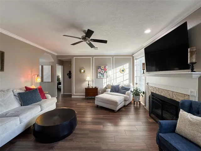 a living room with fireplace furniture and a flat screen tv