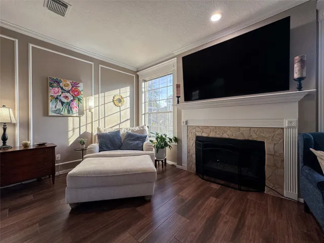 a living room with furniture fireplace and flat screen tv