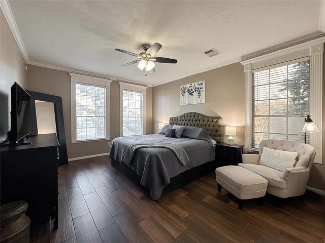 a bedroom with a bed a couch and a window