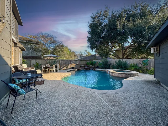 a view of a swimming pool with a table and chairs