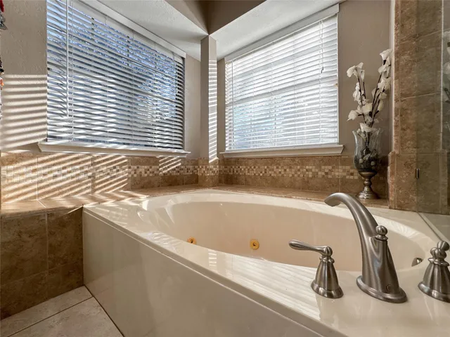 a bath tub sitting in a bathroom next to a window