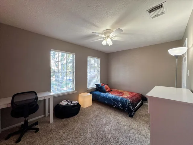 a bedroom with a bed and a chair