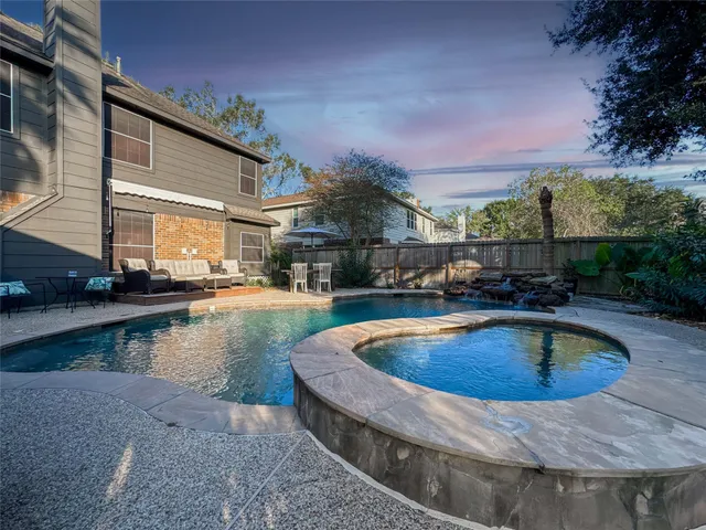 a view of swimming pool with outdoor seating and lake view