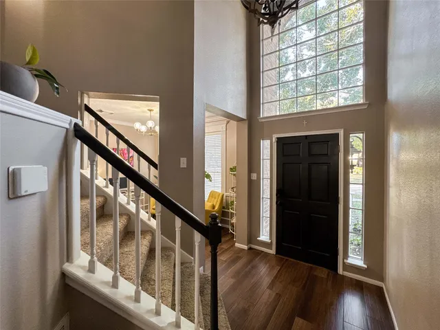 a view of an entryway with wooden floor and stairs