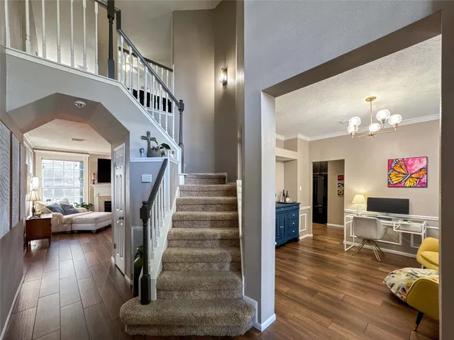 a view of entryway livingroom and hall with wooden floor