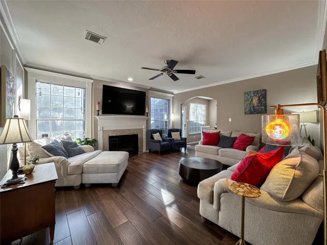a living room with furniture a fireplace and a flat screen tv