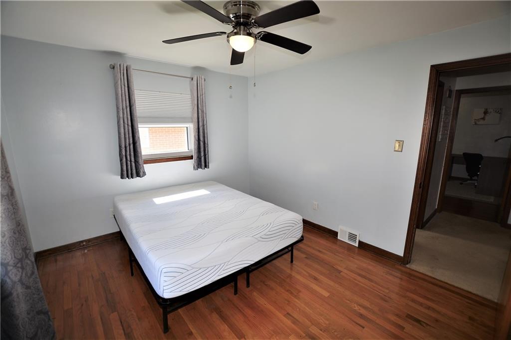 437 Greenridge Road New Kensington, PA 15068 - Photo 14 of 25 an empty room with wooden floor fan and windows