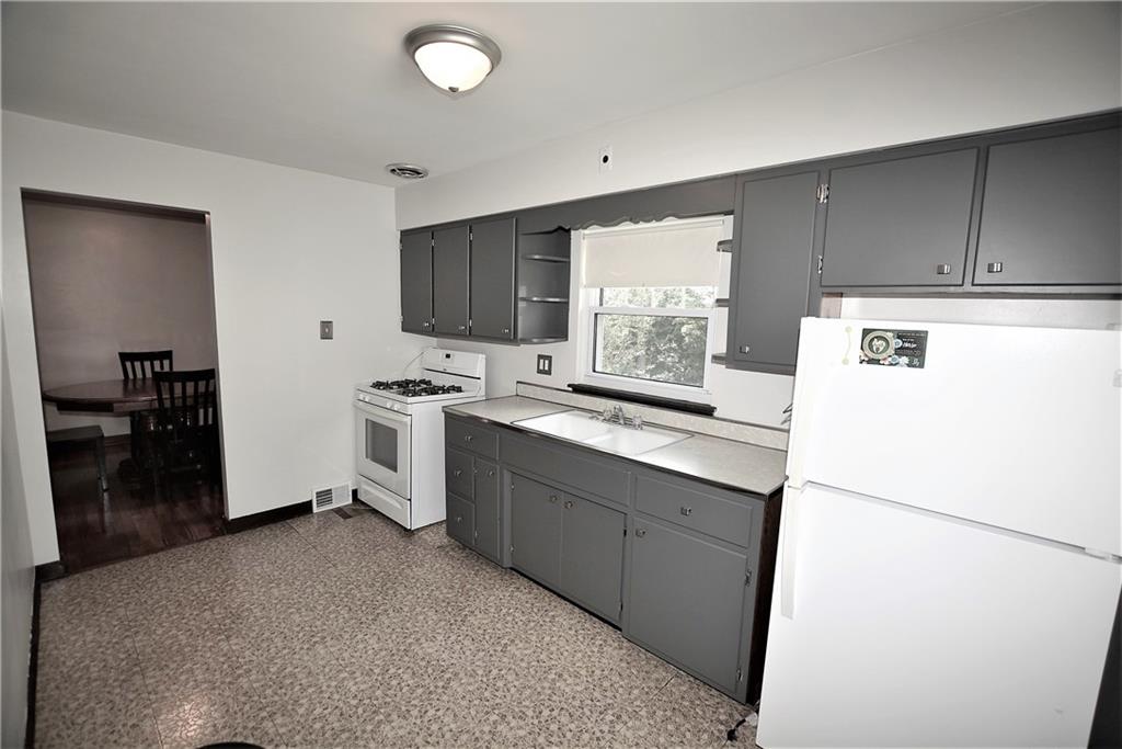 437 Greenridge Road New Kensington, PA 15068 - Photo 5 of 25 a kitchen with a sink a refrigerator and cabinets