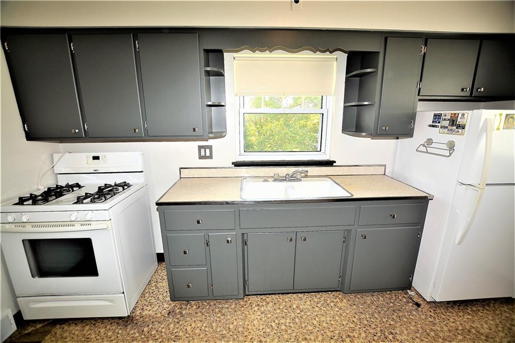 437 Greenridge Road New Kensington, PA 15068 - Photo 6 of 25 a kitchen with a sink stove and cabinets