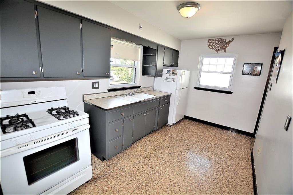 437 Greenridge Road New Kensington, PA 15068 - Photo 7 of 25 a kitchen with stainless steel appliances a stove a sink and a refrigerator