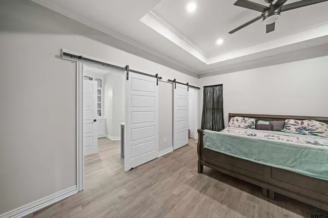 a spacious bedroom with a bed and a dresser