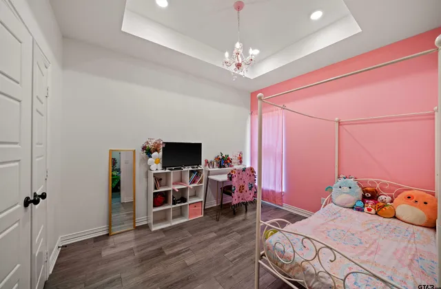 a bedroom with bed and wooden floor