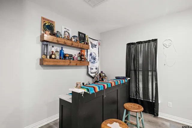 a living room with furniture cabinets and a window