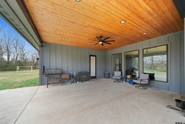 a view of a backyard with table and chairs and garden