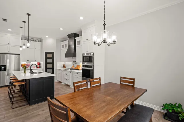 a living room with kitchen island furniture and a chandelier