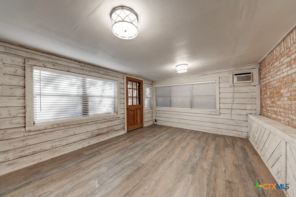 1229 Rapids Road New Braunfels, TX 78130 - Photo 20 of 27 a view of a room with wooden floor and windows