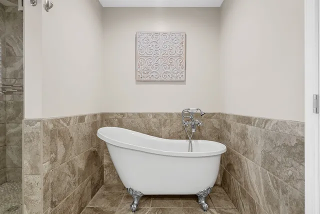 a view of walk in closet with clothes