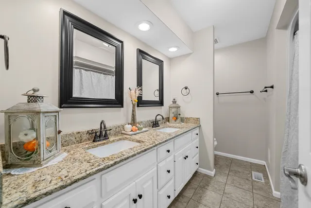 a bedroom with a bed lamp and a large window