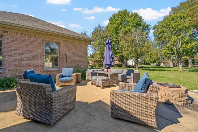 a backyard of a house with barbeque oven table and chairs