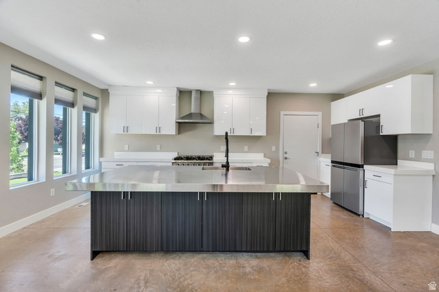 7045 South 300 East Midvale, UT 84047 - Photo 13 of 49 Contemporary kitchen featuring a large central island with a stainless steel countertop and dark wood-finish cabinetry