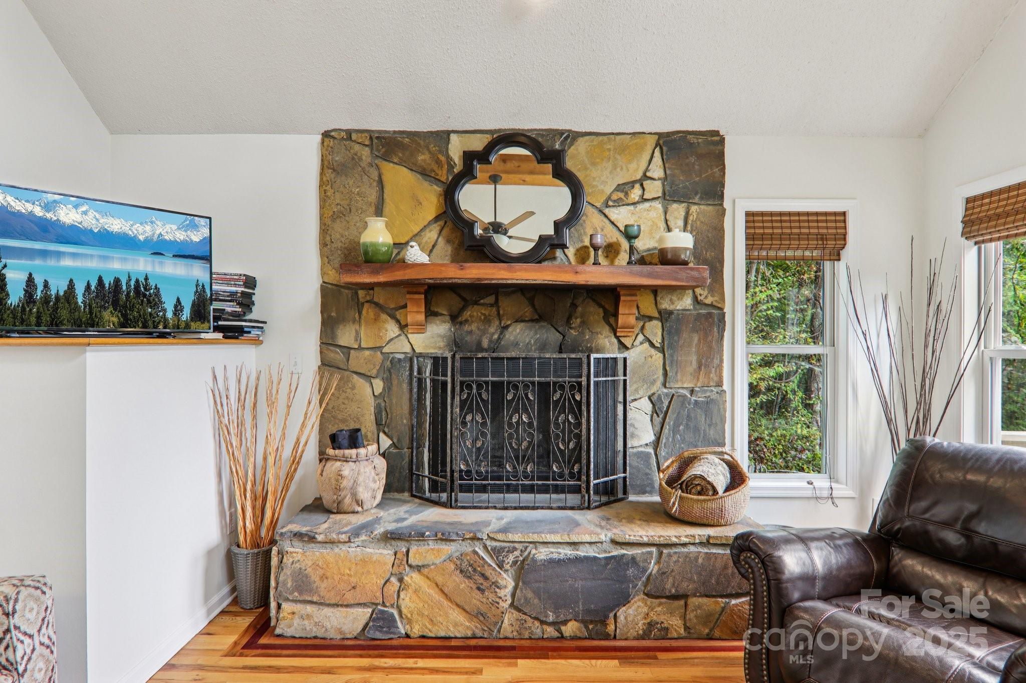311 Jacks Knob Road Barnardsville, NC 28709 - Photo 13 of 48 a living room with furniture a fireplace and a table