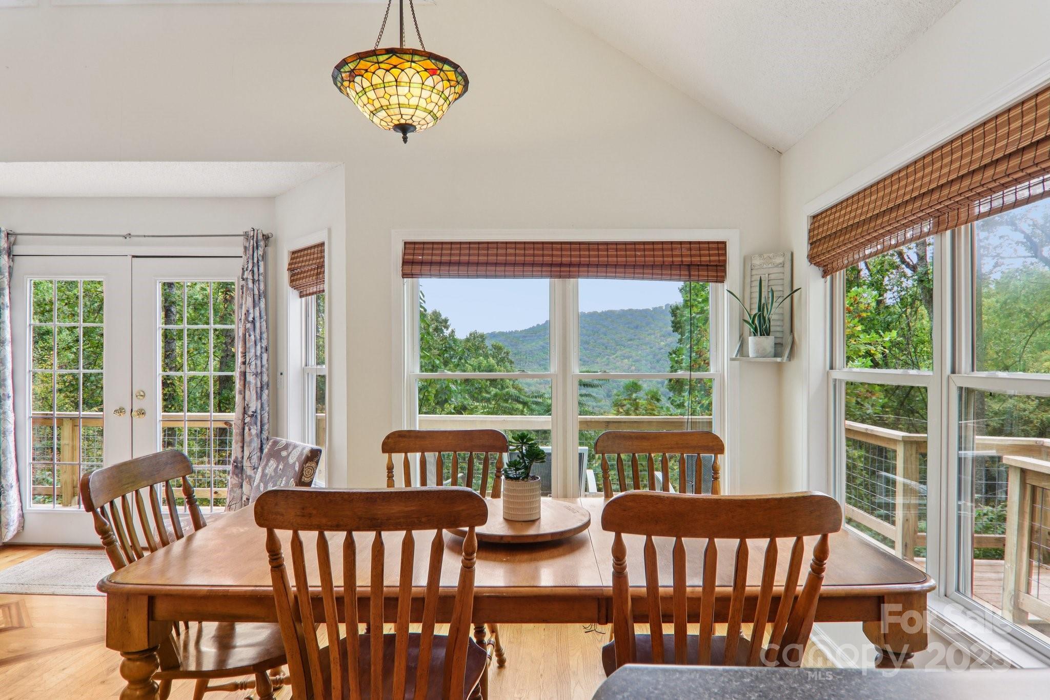 311 Jacks Knob Road Barnardsville, NC 28709 - Photo 20 of 48 a view of a dining room with furniture a chandelier and wooden floor