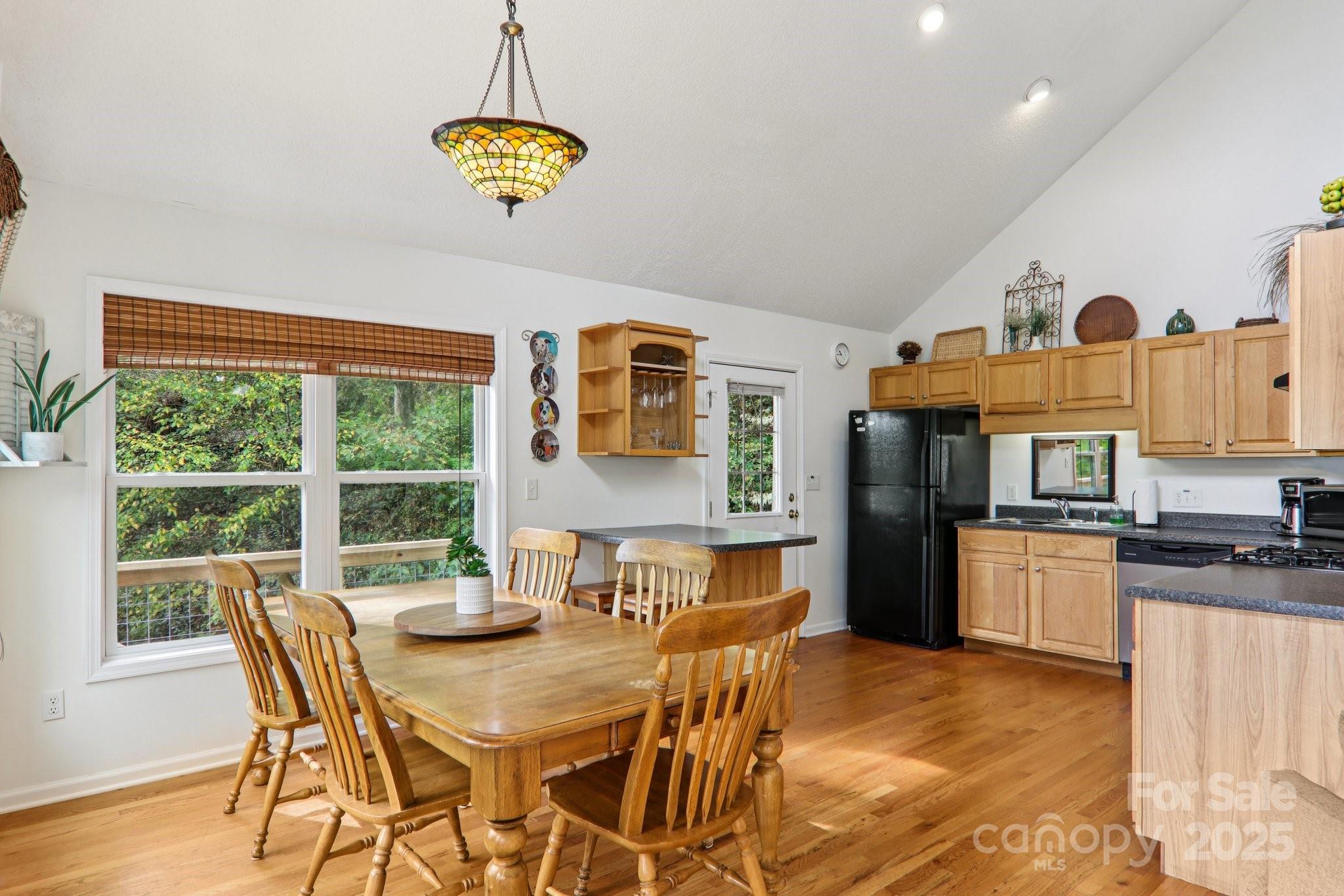 311 Jacks Knob Road Barnardsville, NC 28709 - Photo 23 of 48 a view of a dining room with furniture a chandelier and wooden floor