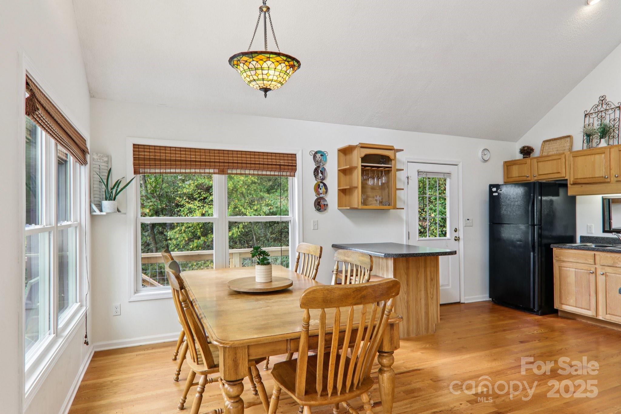 311 Jacks Knob Road Barnardsville, NC 28709 - Photo 24 of 48 a view of a dining room with furniture a chandelier and wooden floor