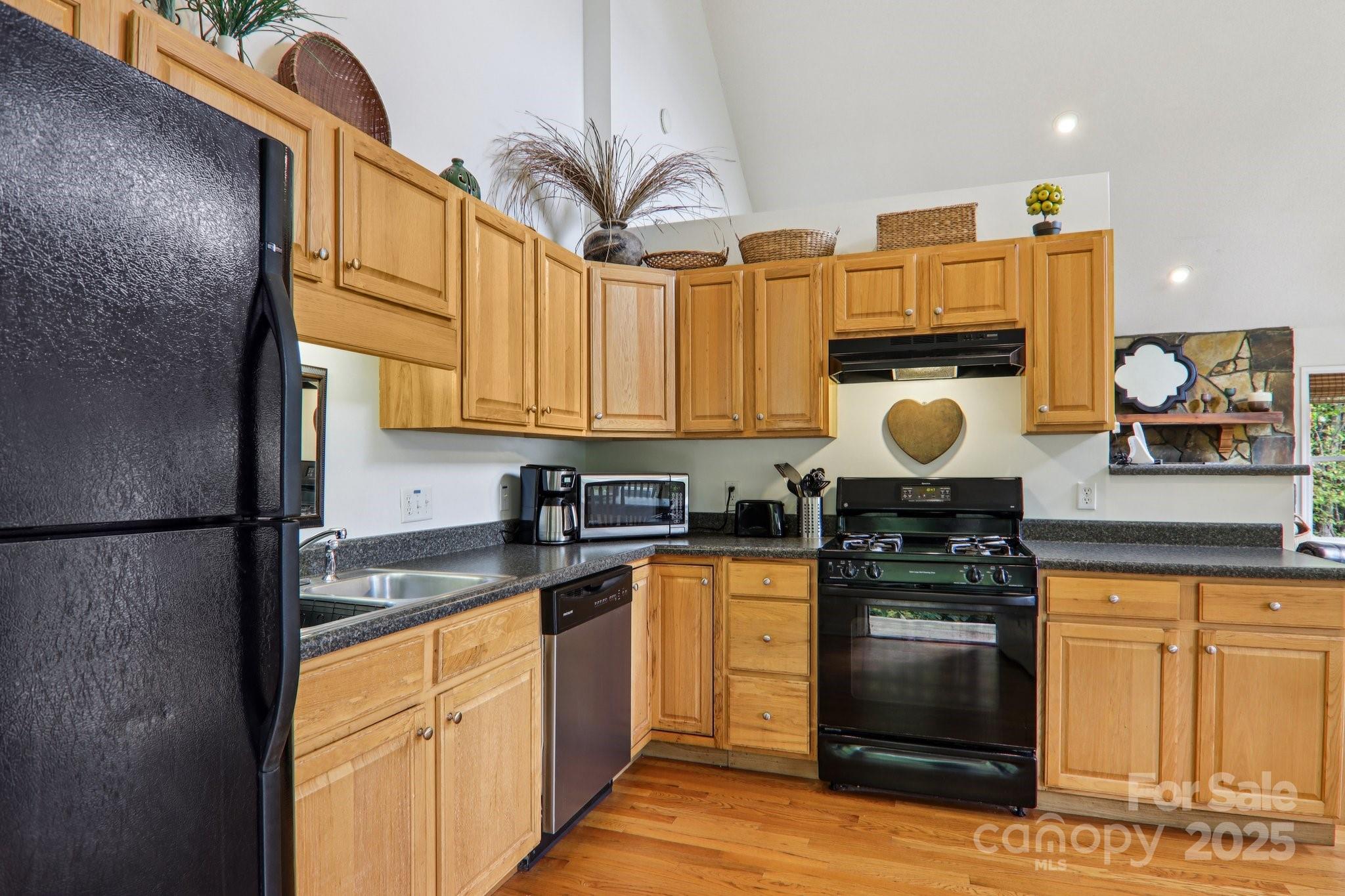 311 Jacks Knob Road Barnardsville, NC 28709 - Photo 29 of 48 a kitchen with stainless steel appliances granite countertop a stove a sink and a refrigerator