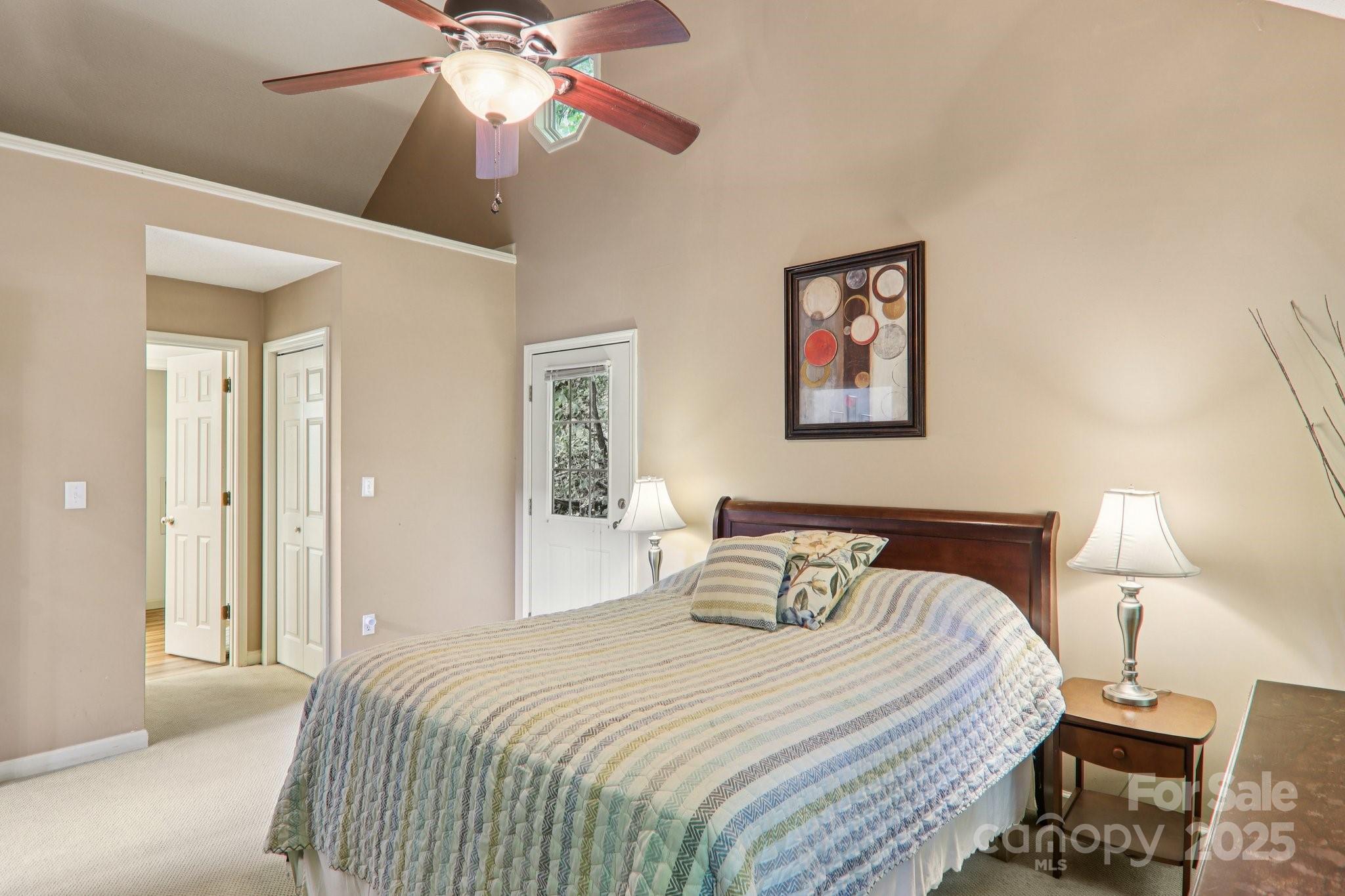 311 Jacks Knob Road Barnardsville, NC 28709 - Photo 33 of 48 a bedroom with a bed and a chandelier