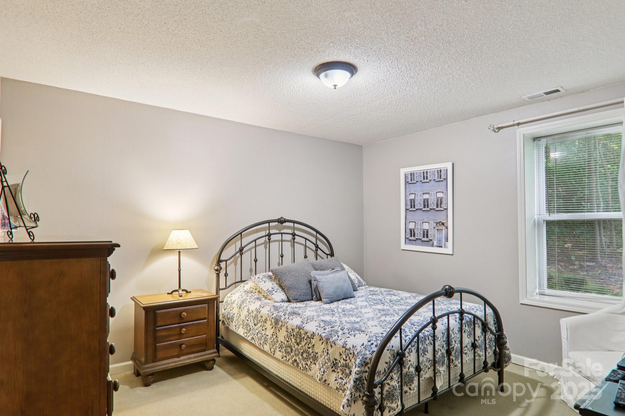 311 Jacks Knob Road Barnardsville, NC 28709 - Photo 40 of 48 a bedroom with a bed next to a window
