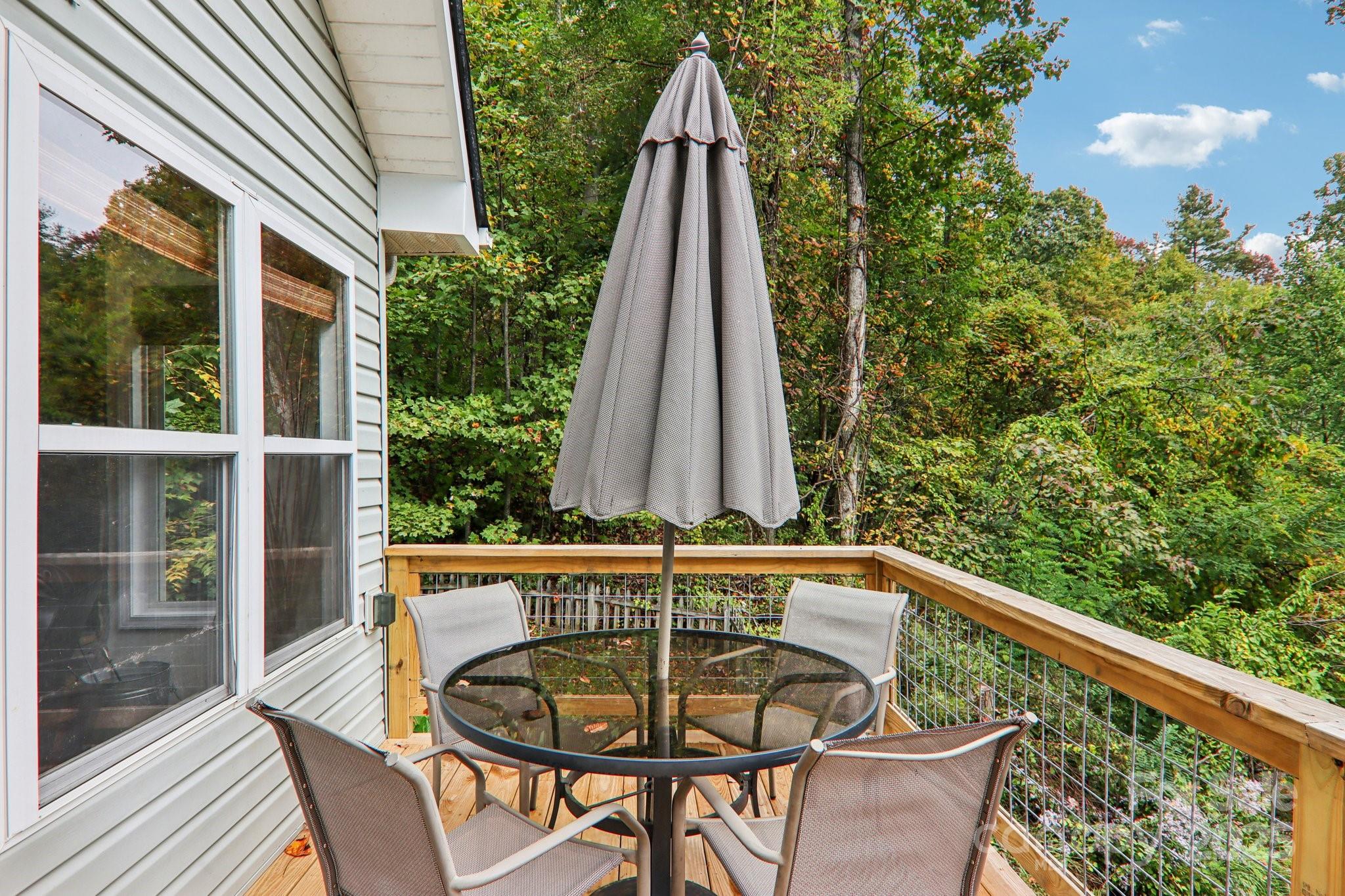 311 Jacks Knob Road Barnardsville, NC 28709 - Photo 6 of 48 a view of a chairs and table in the balcony
