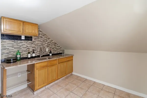 a kitchen with granite countertop white cabinets and stainless steel appliances