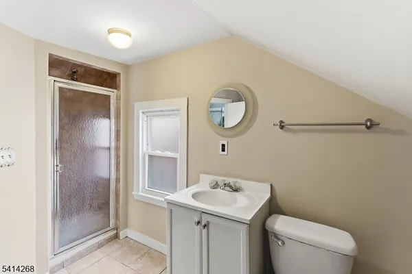 a bathroom with a toilet a sink and a mirror