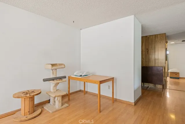 a view of a room with wooden floor wooden table and chairs