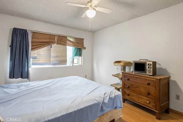a bedroom with a bed and a tv on the dresser