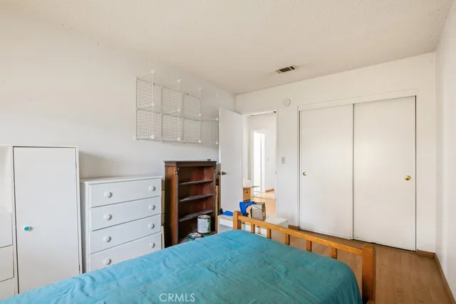 a bedroom with a bed and a closet