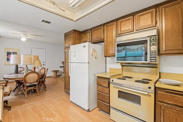 a kitchen with a refrigerator a stove top oven cabinetry a stove and a refrigerator