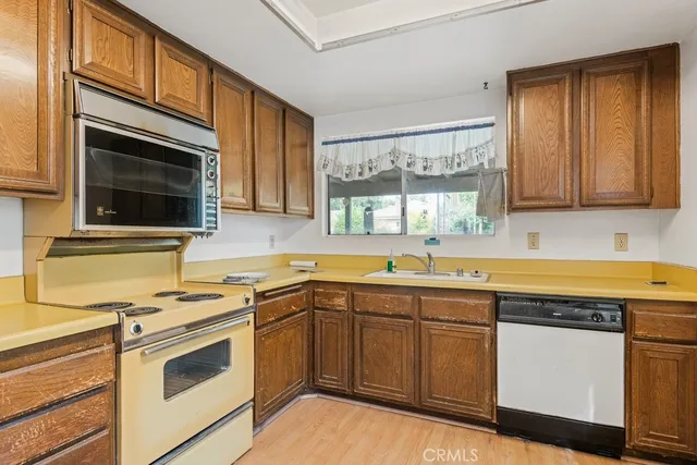 a kitchen with stainless steel appliances granite countertop a sink stove and microwave