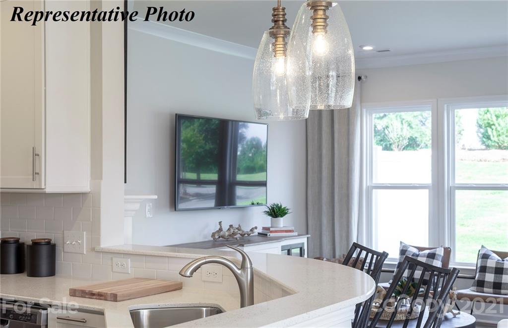 467 Hunters Dance Road, Unit 340 Fort Mill, SC 29708 - Photo 6 of 19 a kitchen with a table chairs and window