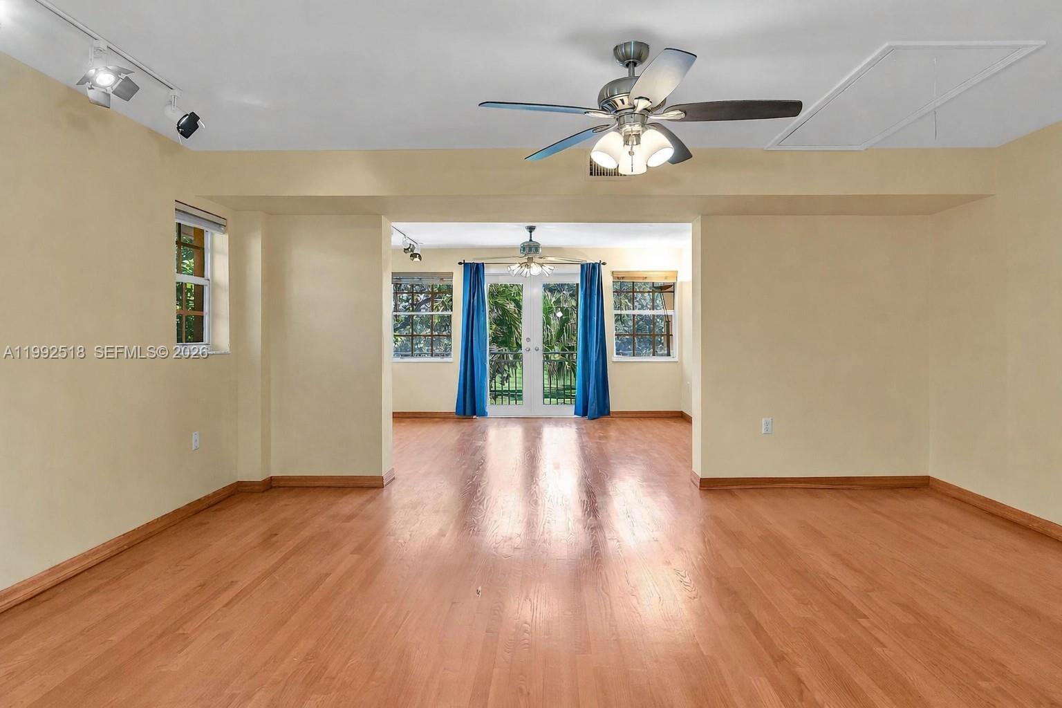 5309 Alton Road Miami Beach, FL 33140 - Photo 19 of 51 a view of an empty room with wooden floor and a window