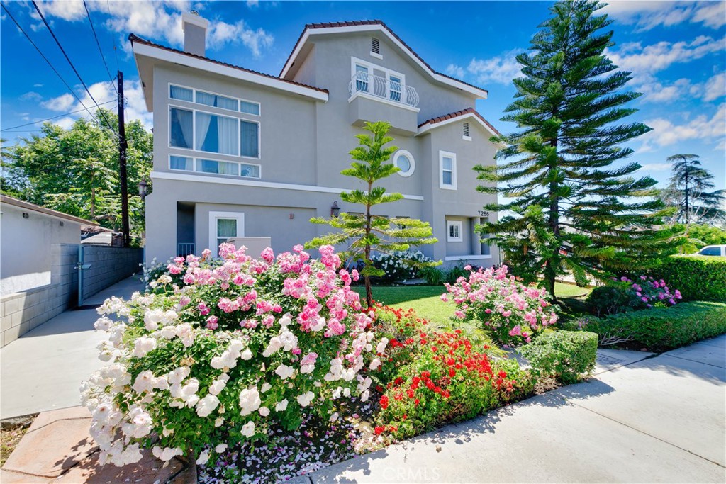 a front view of a house with a yard and fountain