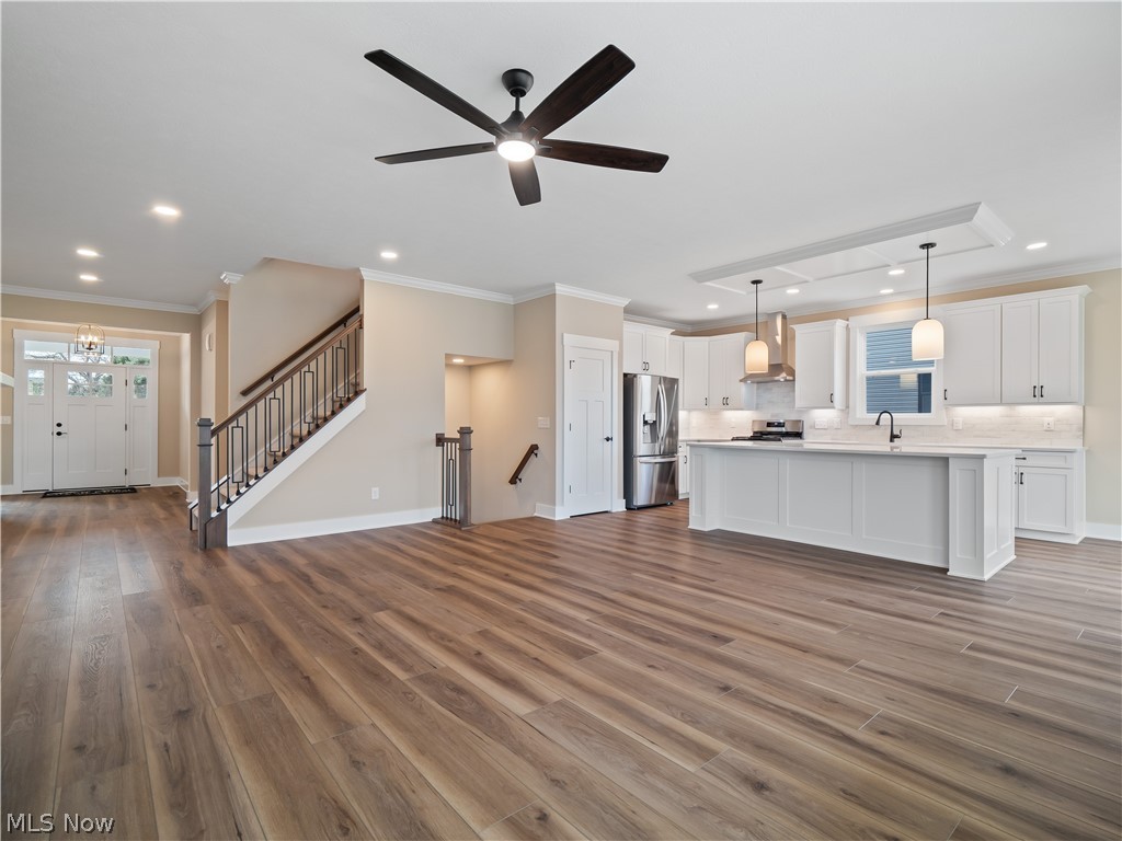 34270 Brookside Lane North Ridgeville, OH 44039 - Photo 12 of 50 Unfurnished living room featuring ornamental molding, dark wood finished floors, recessed lighting, and ceiling fan