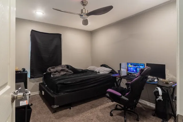 a bedroom with a bed and a desk